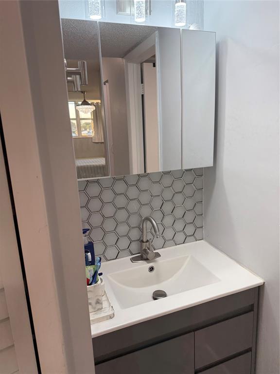 9360 Lime Bay Boulevard, Unit 202 Tamarac, FL 33321 - Photo 6 of 15 a bathroom with a sink and a mirror
