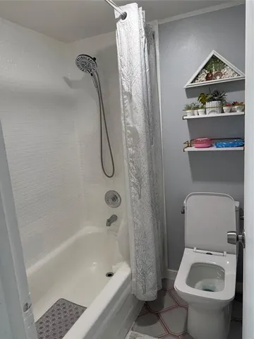 a bathroom with a shower a toilet and a shower