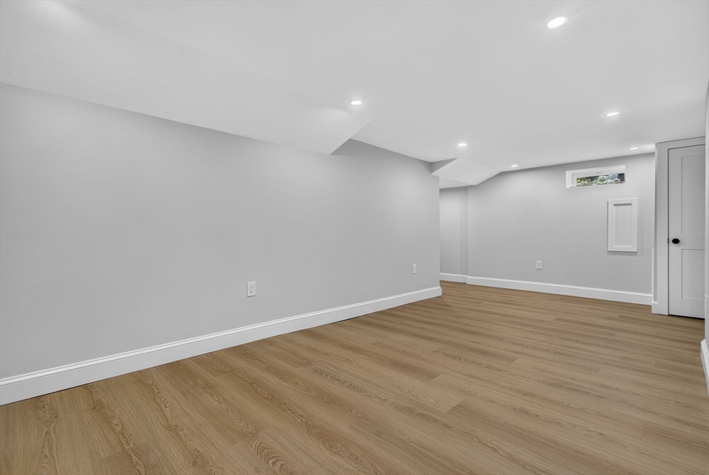 20 Saltonstall Road Medford, MA 02155 - Photo 35 of 41 a view of an empty room with wooden floor and a bathroom
