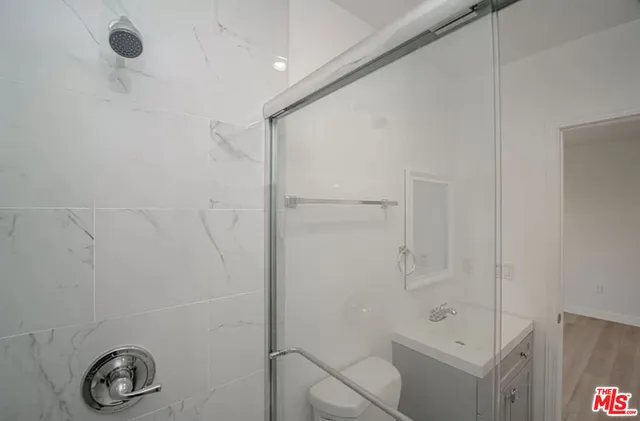 a bathroom with a shower and a sink