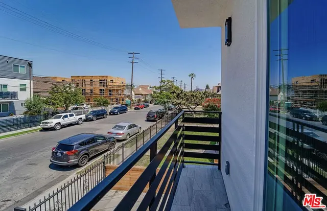 a view of a balcony and car parked