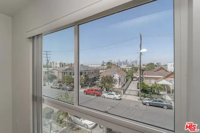 a view of a livingroom with furniture and floor to ceiling window
