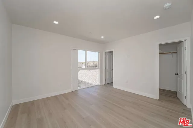 a view of wooden floor and windows in a room