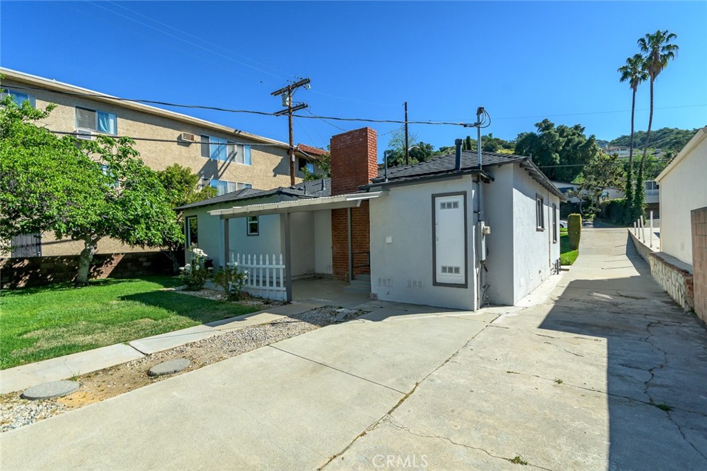 2111 North Verdugo Road Glendale, CA 91208 - Photo 42 of 53 a front view of a house with a garden and garage