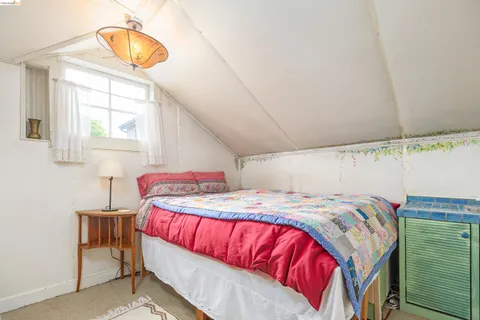 a bedroom with furniture and a large window