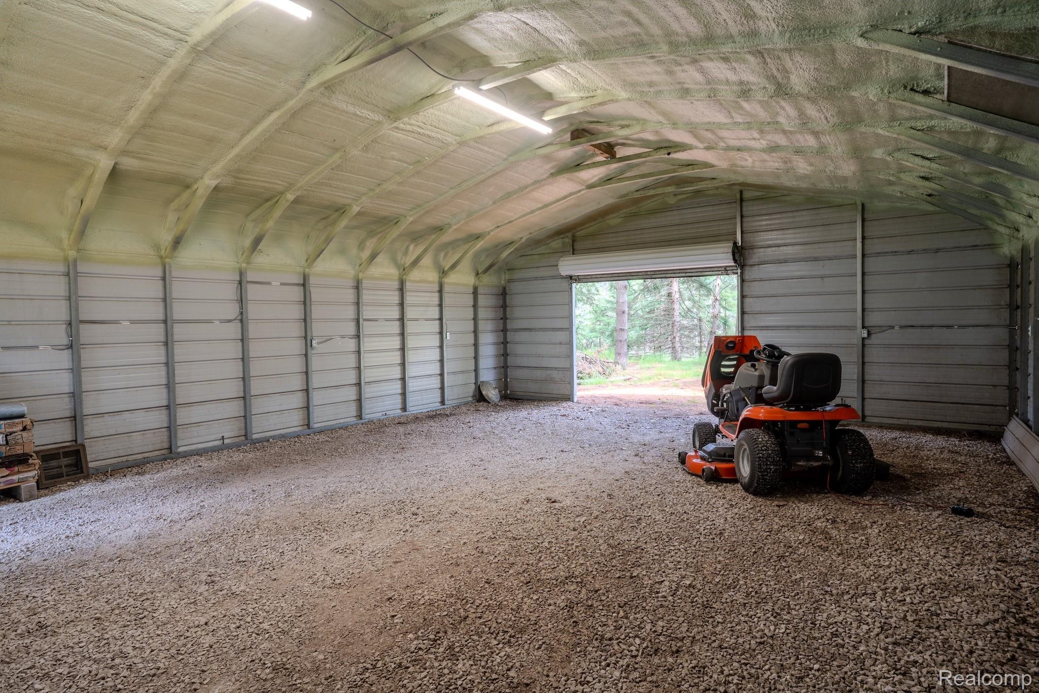 4350 Shrew Road Lincoln, MI 48742 - Photo 27 of 32 Spacious metal building featuring a gravel floor, arched ceiling, and spray foam insulation