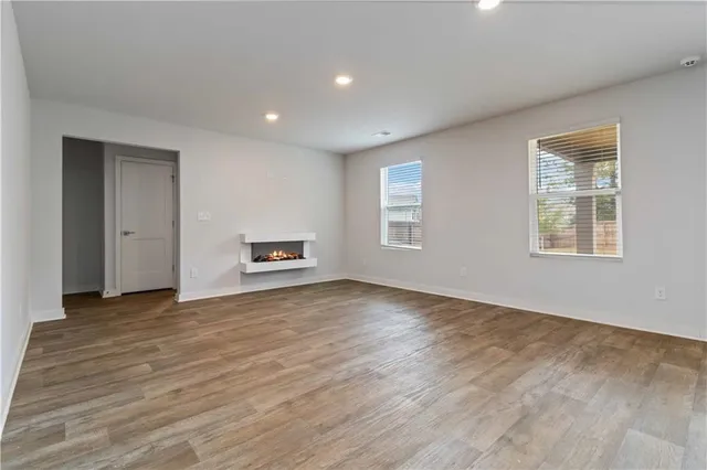 a view of a livingroom with wooden floor and a window