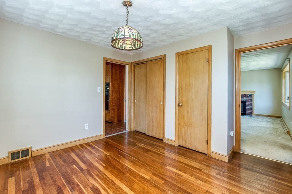 15 Locust Street Dedham, MA 02026 - Photo 11 of 38 a view of an empty room with wooden floor