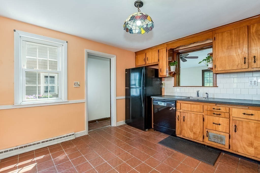 15 Locust Street Dedham, MA 02026 - Photo 12 of 38 a kitchen with stainless steel appliances granite countertop a refrigerator and a sink