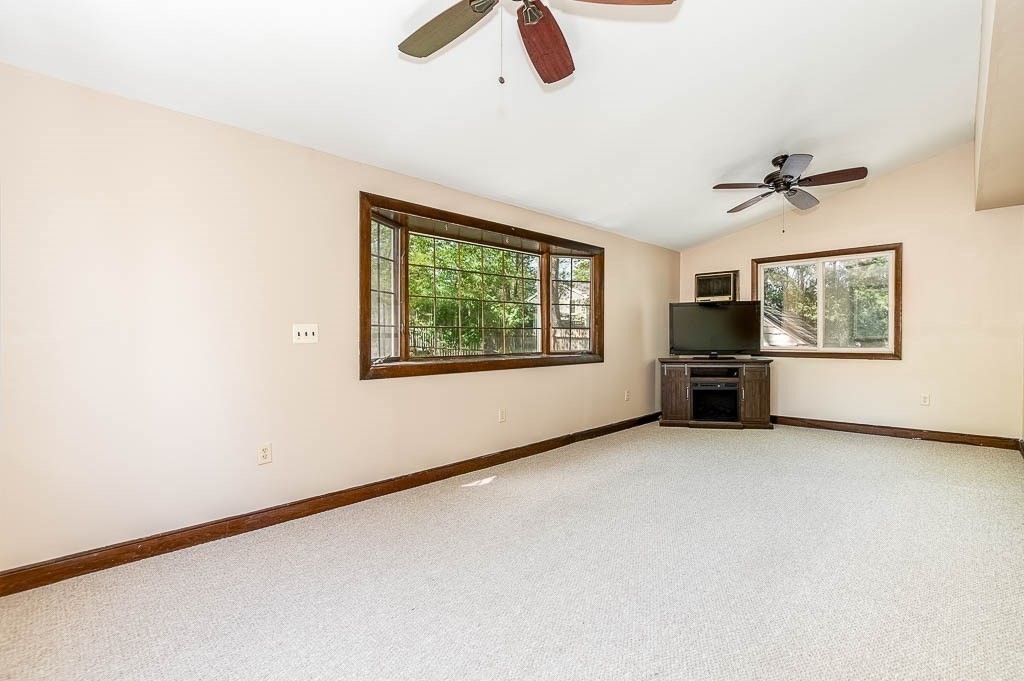 15 Locust Street Dedham, MA 02026 - Photo 15 of 38 an empty room with ceiling fan and windows