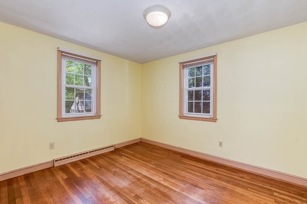 15 Locust Street Dedham, MA 02026 - Photo 19 of 38 a view of empty room with wooden floor and fan