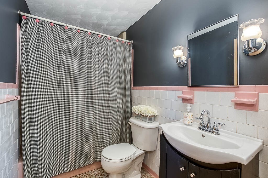 15 Locust Street Dedham, MA 02026 - Photo 20 of 38 a bathroom with a sink a toilet and mirror