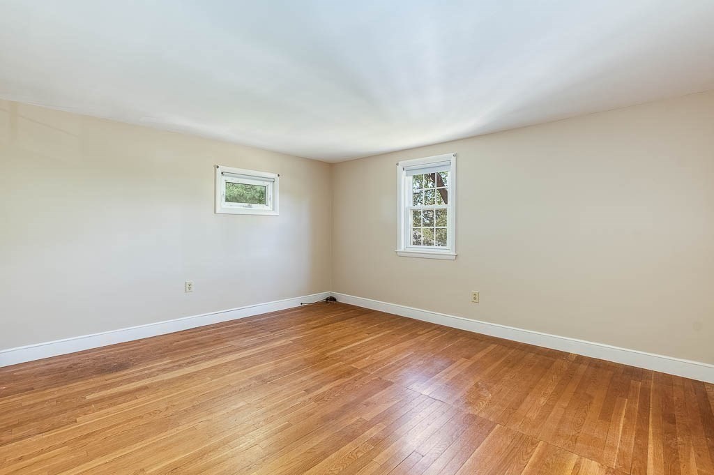 15 Locust Street Dedham, MA 02026 - Photo 21 of 38 a view of an empty room with wooden floor and a window