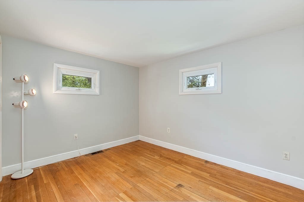15 Locust Street Dedham, MA 02026 - Photo 23 of 38 an empty room with wooden floor and windows