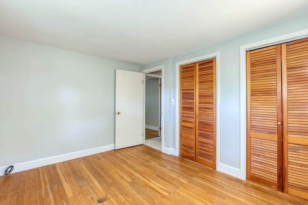 15 Locust Street Dedham, MA 02026 - Photo 24 of 38 a view of empty room with wooden floor and fan