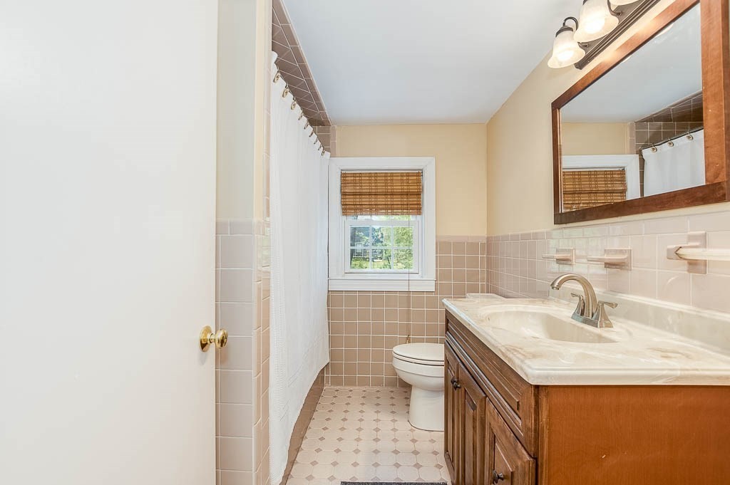 15 Locust Street Dedham, MA 02026 - Photo 25 of 38 a bathroom with a sink and a mirror