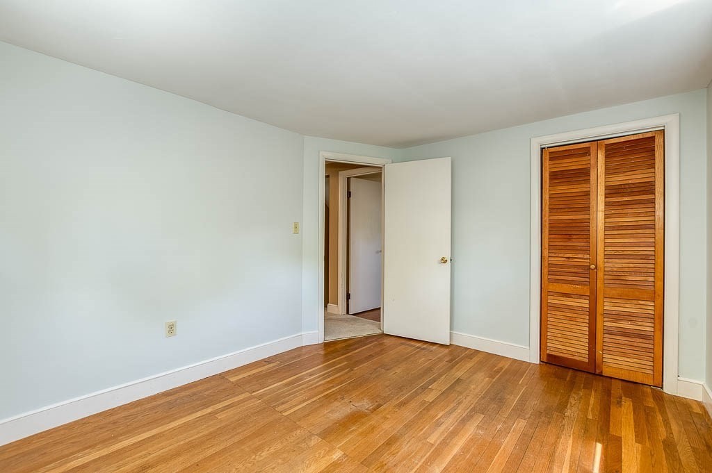 15 Locust Street Dedham, MA 02026 - Photo 27 of 38 a view of an empty room with wooden floor and closet