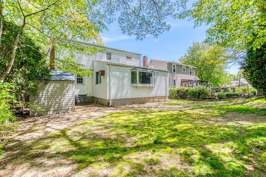 15 Locust Street Dedham, MA 02026 - Photo 34 of 38 a backyard of a house with table and chairs