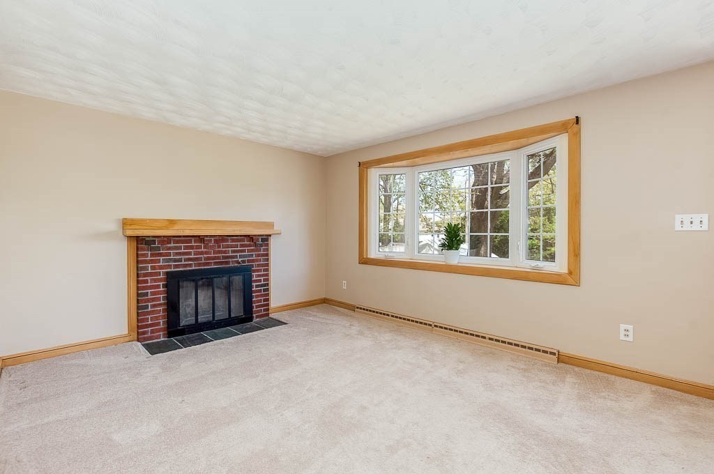 15 Locust Street Dedham, MA 02026 - Photo 7 of 38 an empty room with windows and fireplace