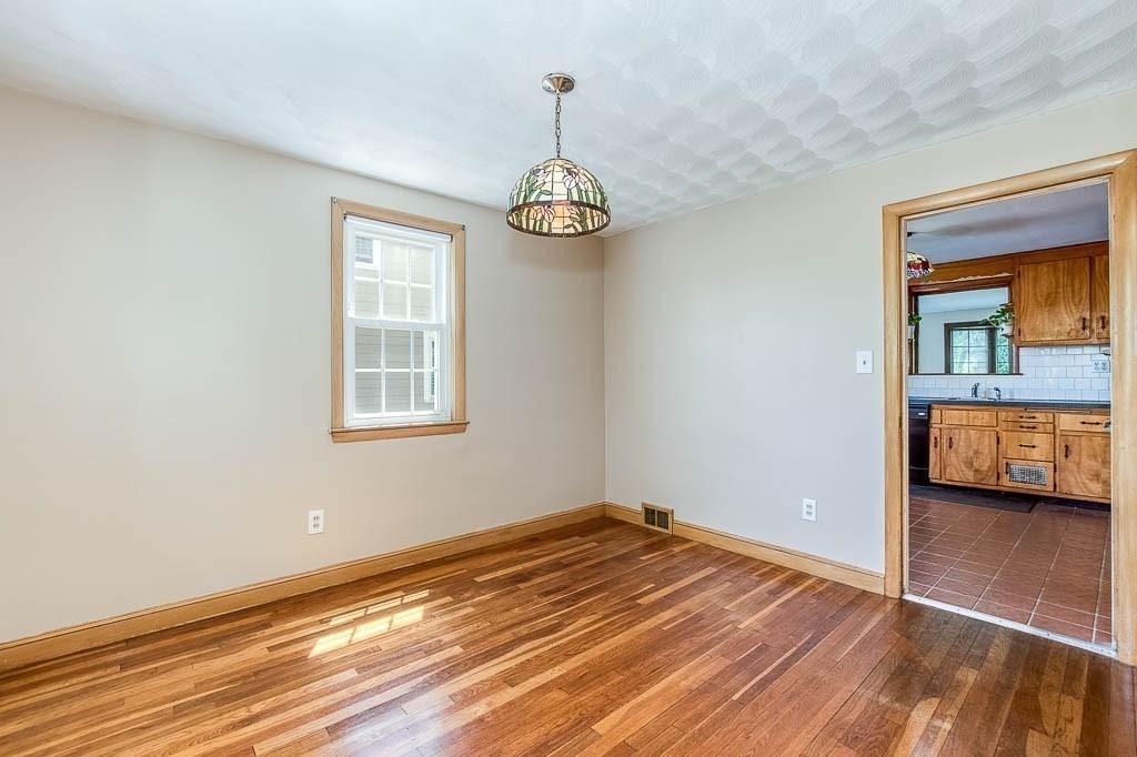 15 Locust Street Dedham, MA 02026 - Photo 10 of 38 a view of a livingroom with wooden floor and a ceiling fan