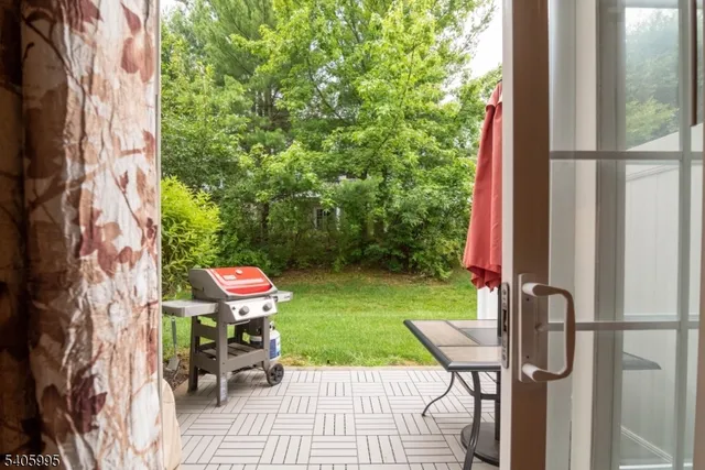 a backyard of a house with table and chairs