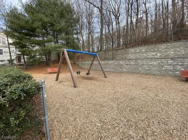 a view of outdoor space with playground and green space