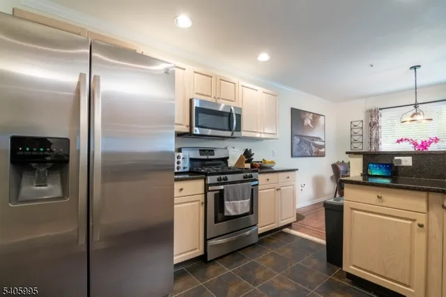 a kitchen with a sink stainless steel appliances and cabinets