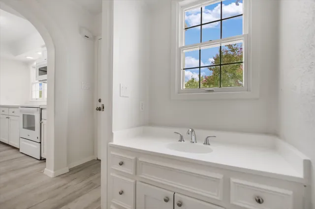 a bathroom with a sink and a window
