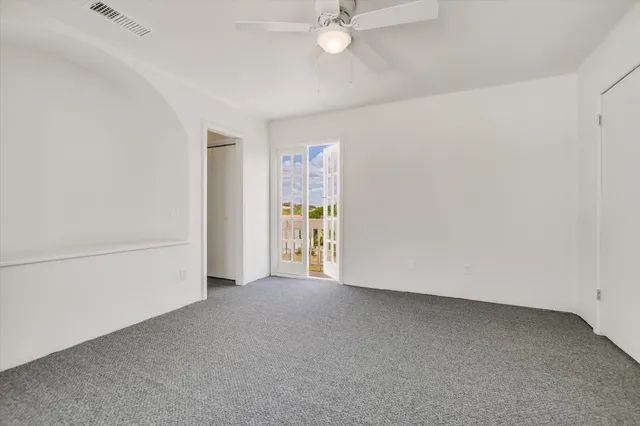 an empty room with a empty space and windows