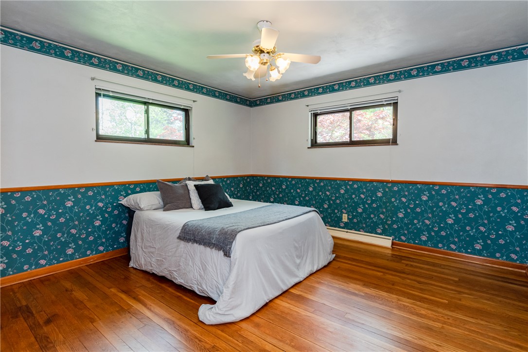 1176 Geneva Road Dayton, OH 45434 - Photo 19 of 55 This spacious bedroom features lustrous hardwood floors and abundant natural light from multiple windows.