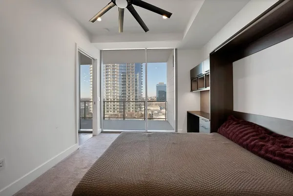 a spacious bedroom with a large bed and a large window