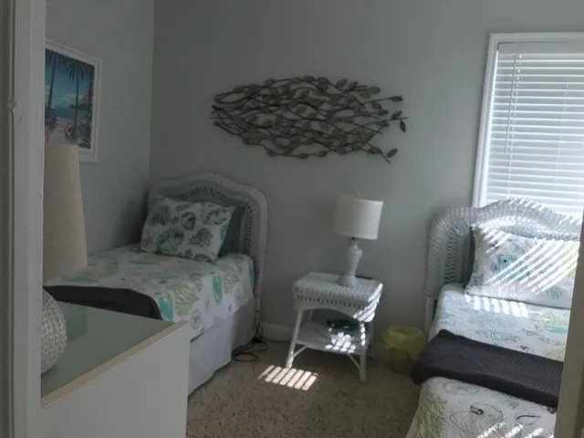 a bed sitting in a bedroom next to a window