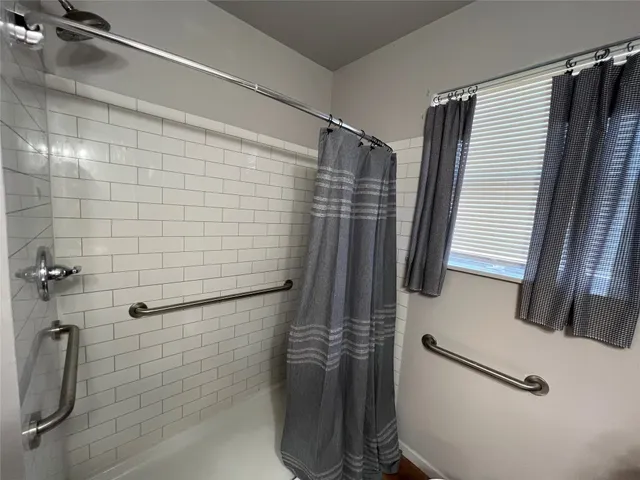 a bathroom with a shower and a sink