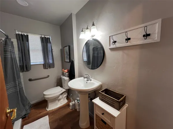 a bathroom with a toilet sink and mirror