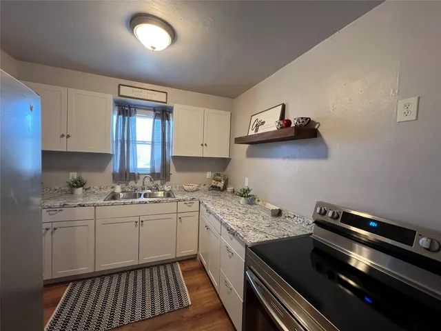 a kitchen with a sink stove and cabinets