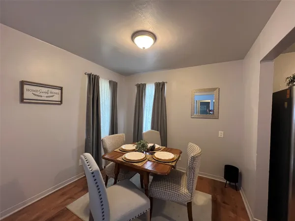 a view of a dining room with furniture and wooden floor