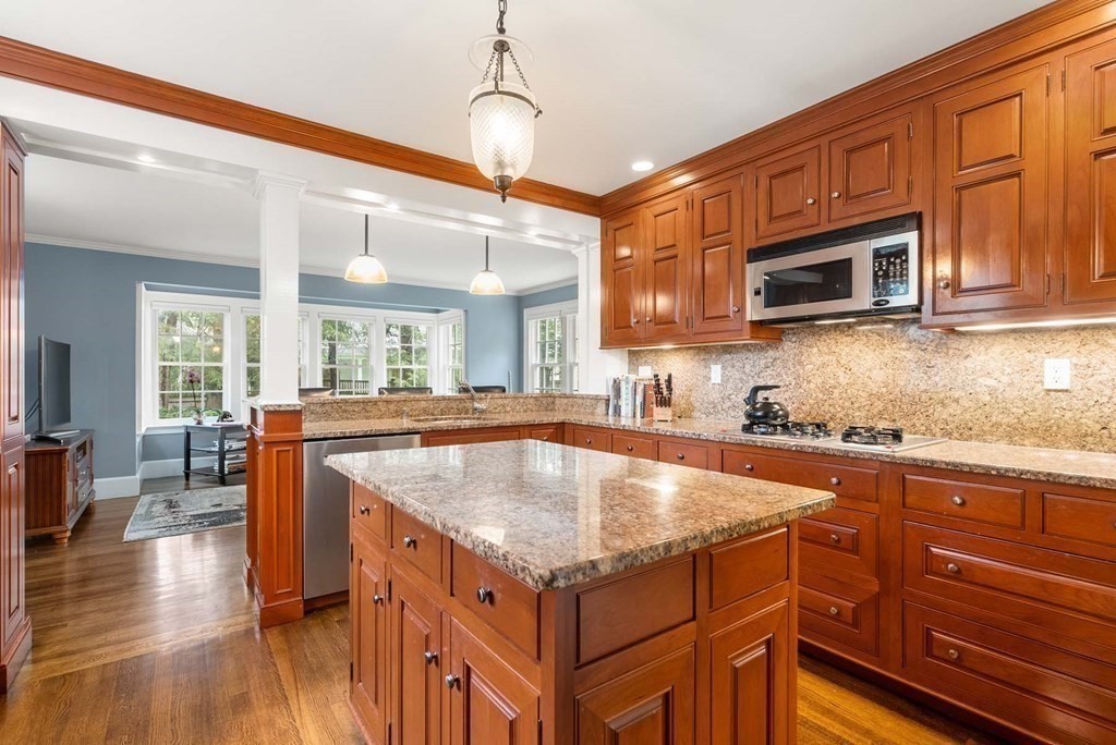 22 Barnstable Road Newton, MA 02465 - Photo 14 of 41 a kitchen with stainless steel appliances granite countertop a stove a sink and a microwave