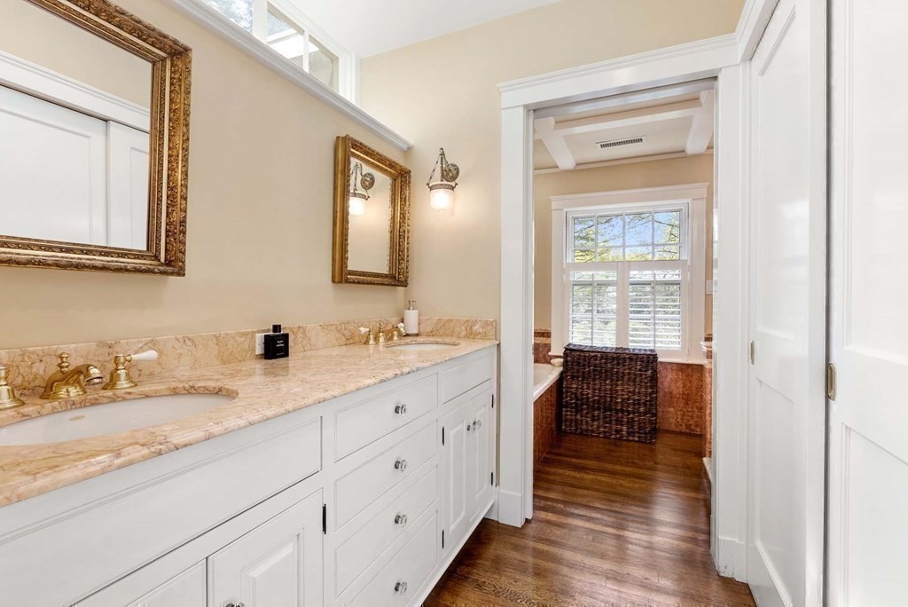 22 Barnstable Road Newton, MA 02465 - Photo 22 of 41 a en suite bathroom with a granite countertop sink and a mirror