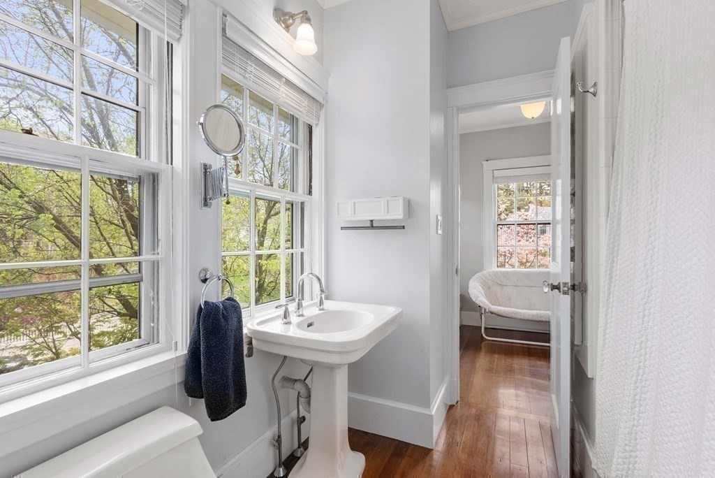 22 Barnstable Road Newton, MA 02465 - Photo 28 of 41 a bathroom with a sink a mirror and a window