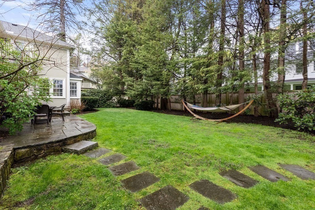 22 Barnstable Road Newton, MA 02465 - Photo 36 of 41 a view of a backyard with couches plants and large tree