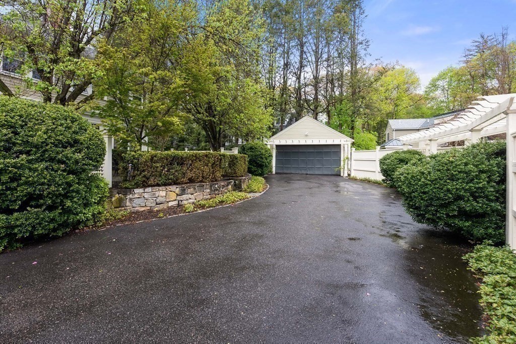22 Barnstable Road Newton, MA 02465 - Photo 38 of 41 a wooden bench sitting in front of a building