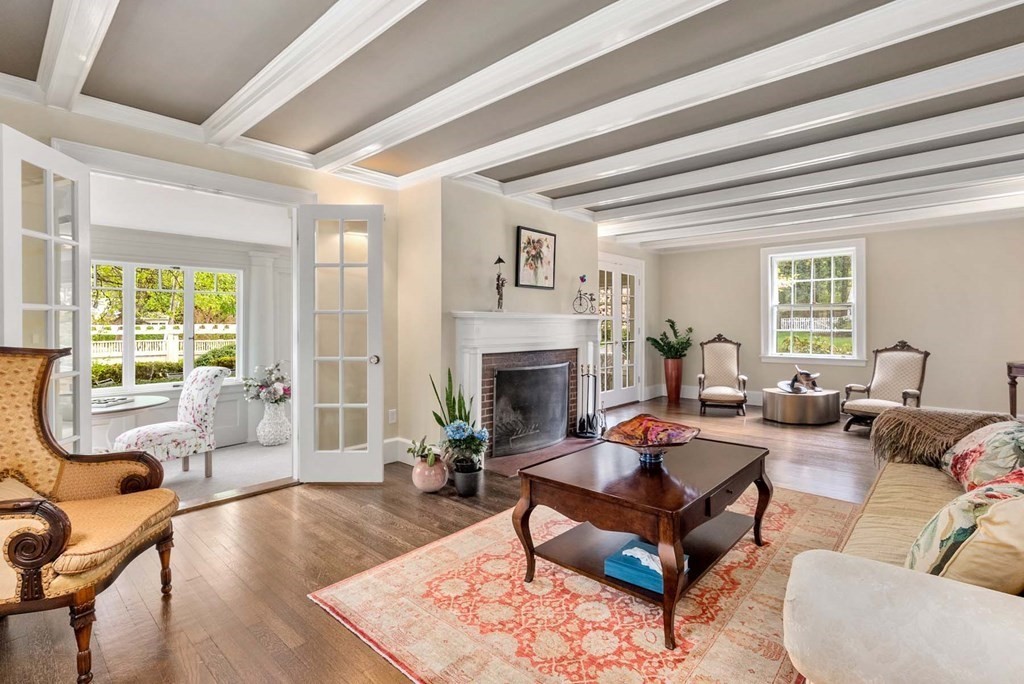 22 Barnstable Road Newton, MA 02465 - Photo 8 of 41 a living room with furniture a fireplace and a large window
