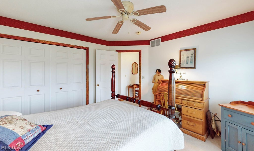 10147 Page Road Streetsboro, OH 44241 - Photo 23 of 35 Bedroom featuring a closet, light carpet, and ceiling fan