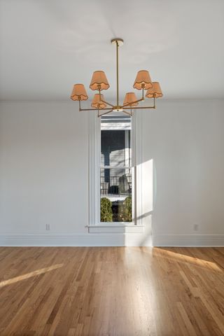 a view of empty room with a fireplace and wooden floor