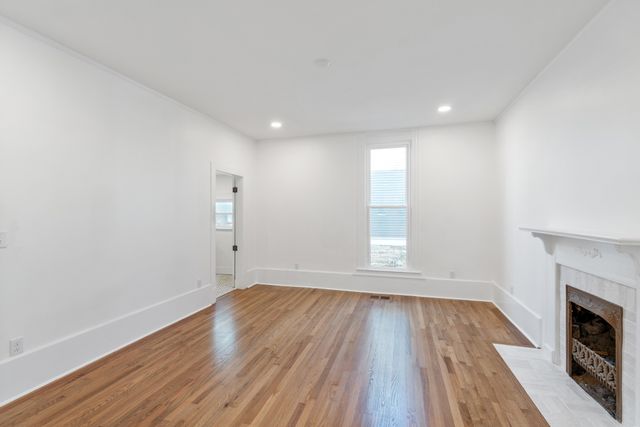 a kitchen with granite countertop a stove and a wooden floor