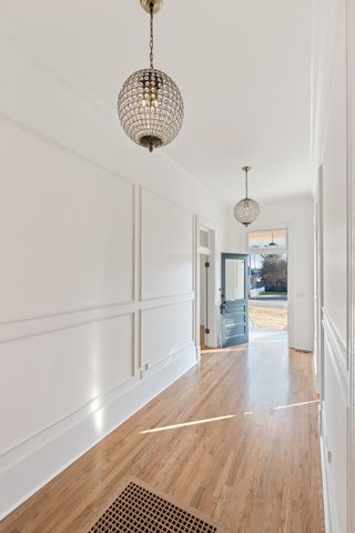 a view of a room with wooden floor and windows
