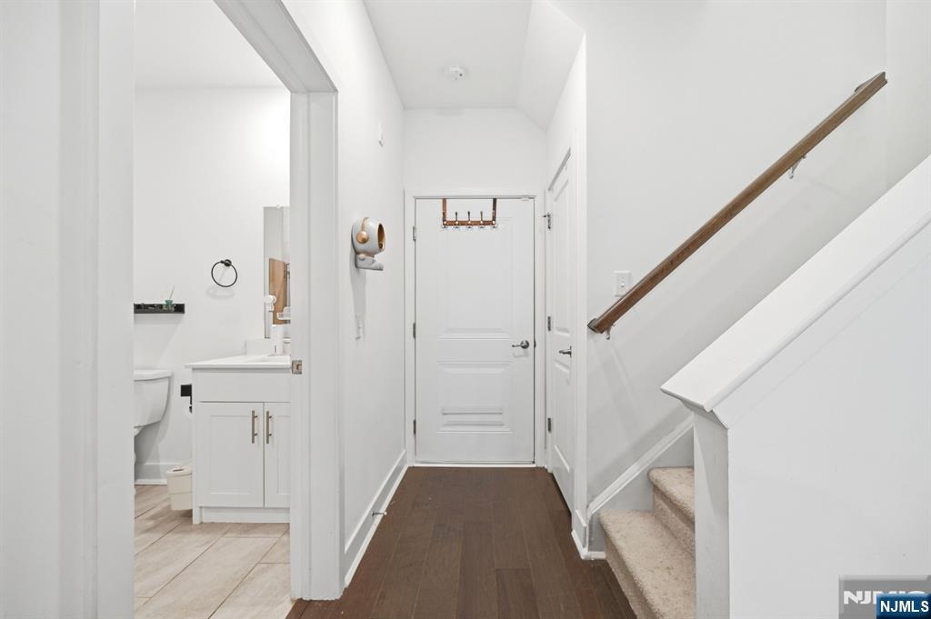 385 Main Street Little Falls, NJ 07424 - Photo 17 of 42 a view of a hallway with white walls and stairs