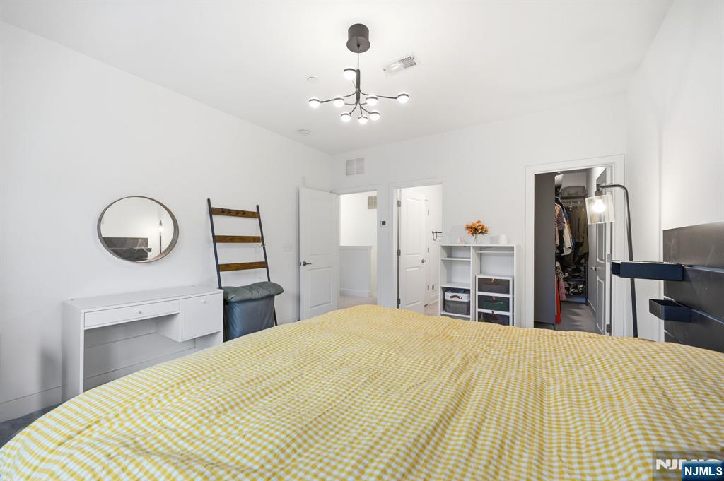 385 Main Street Little Falls, NJ 07424 - Photo 22 of 42 a bedroom with a bed and wooden floor