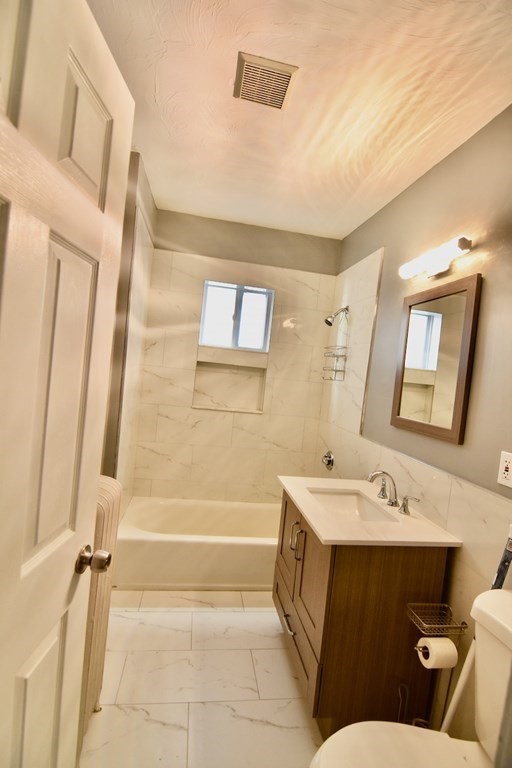 21 Treadway Road, Unit 2 Boston, MA 02125 - Photo 11 of 21 a bathroom with a sink a toilet and shower