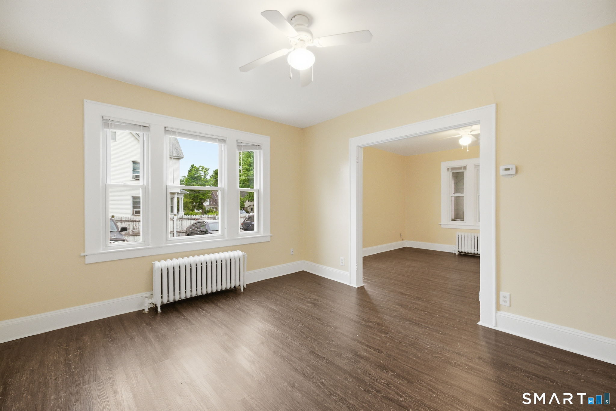 76 Harold Street Hartford, CT 06112 - Photo 9 of 12 an empty room with wooden floor and windows